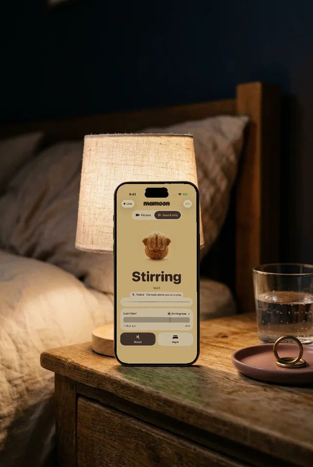 A phone with Mamoon on the bedside table, muted, showing Stirring